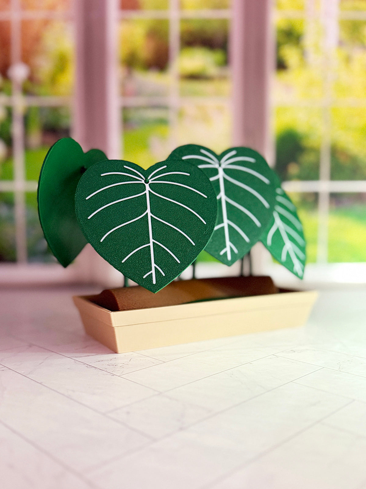 3D-printed Philodendron plowmanii coaster set with secret compartment displayed assembled as a decorative plant with detachable leaf coasters.