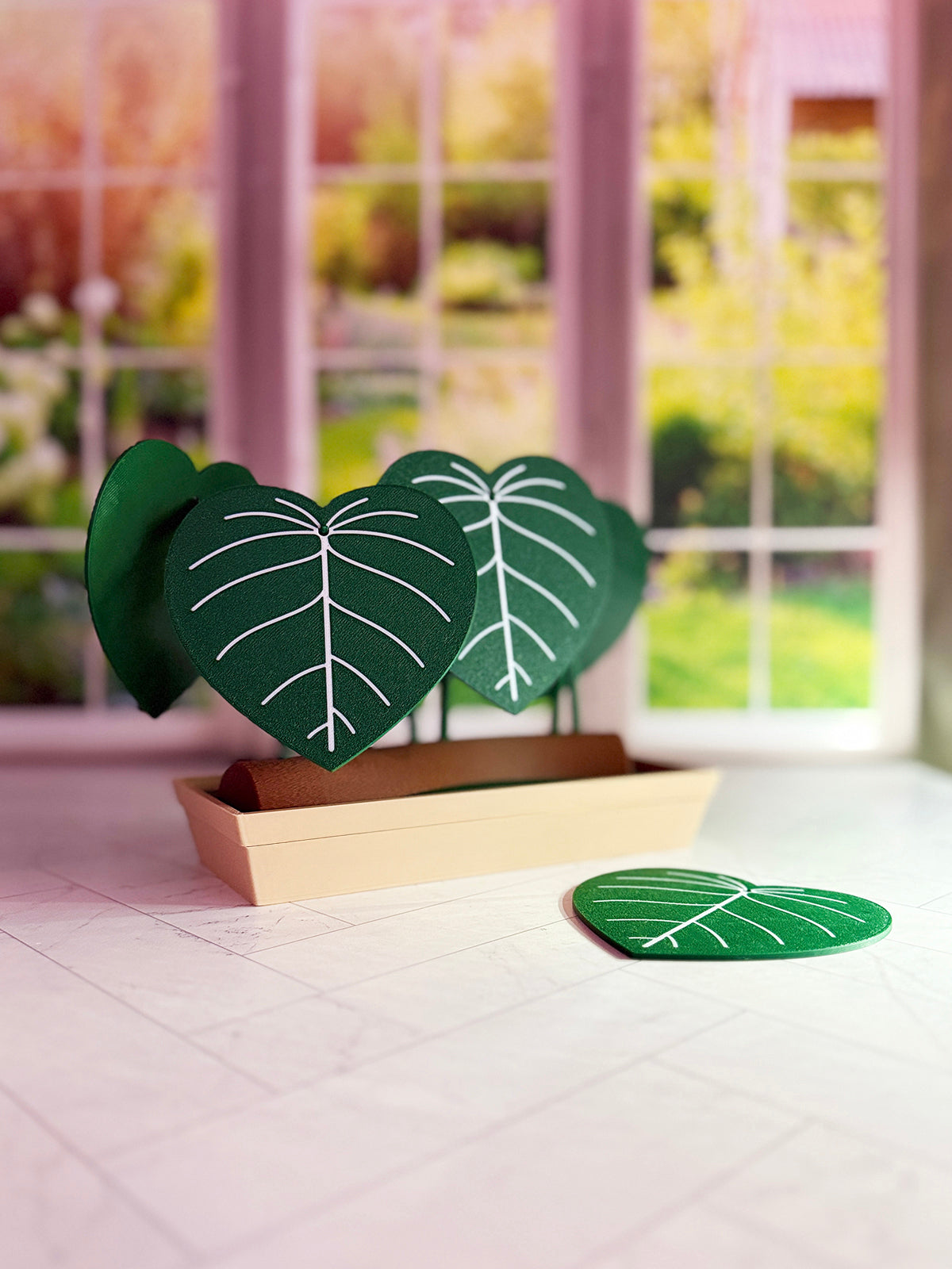 3D-printed Philodendron plowmanii coaster set with secret compartment displayed assembled as a decorative plant with detachable leaf coasters.