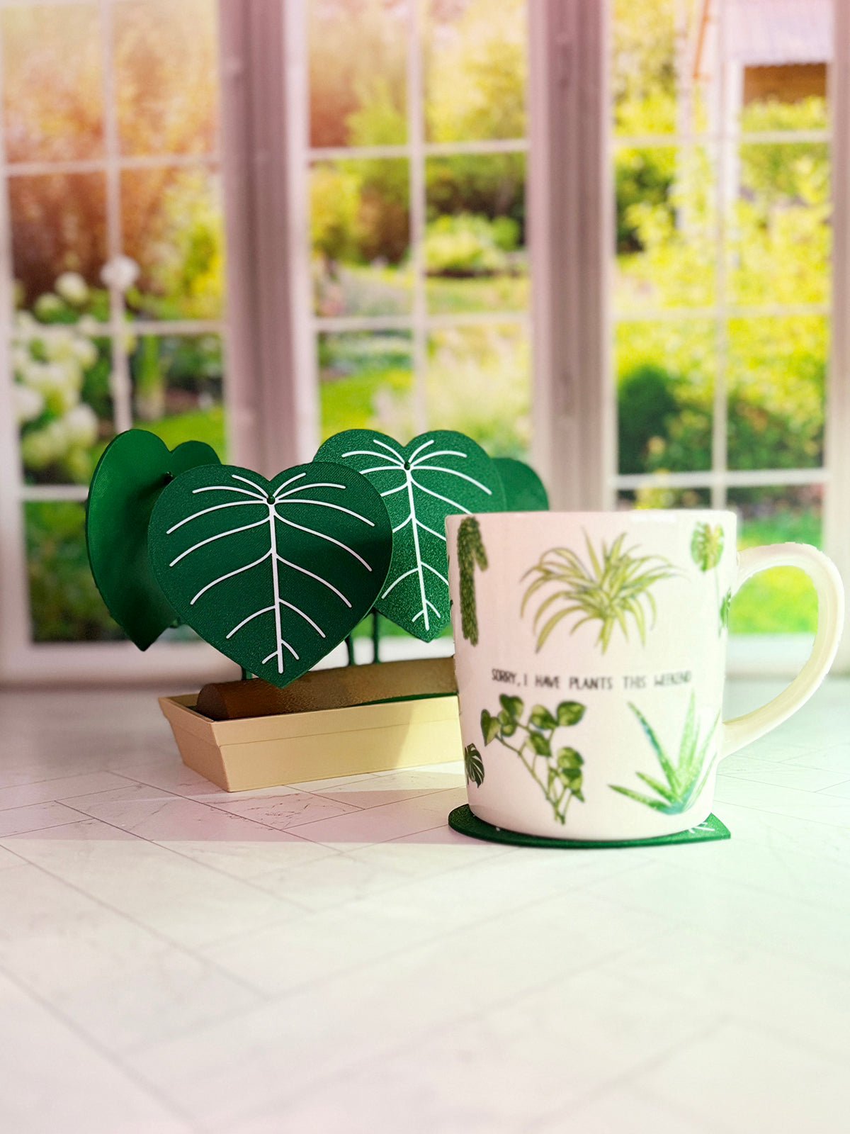 3D-printed Philodendron plowmanii coaster set with secret compartment displayed assembled as a decorative plant with detachable leaf coasters.
