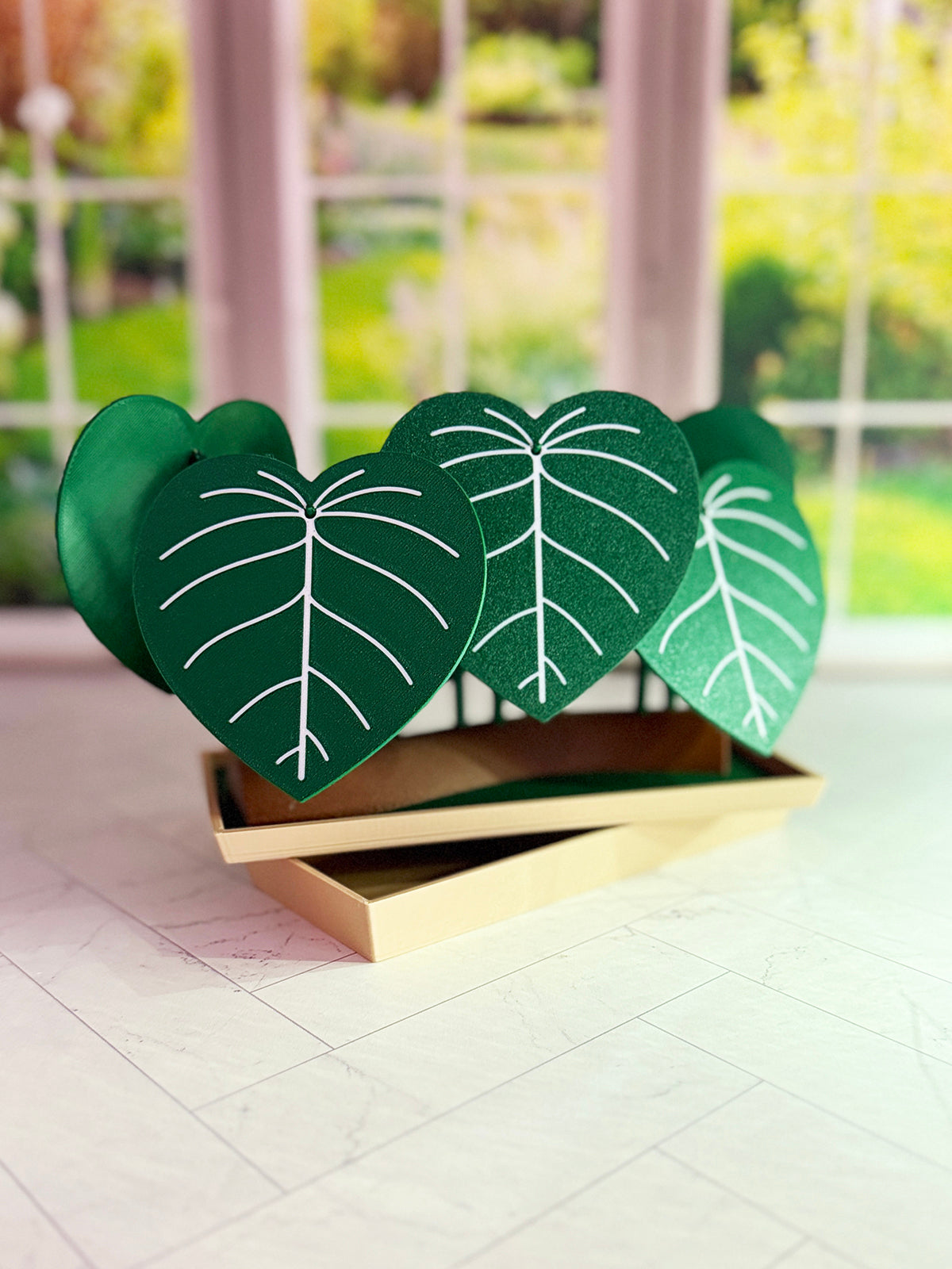 3D-printed Philodendron plowmanii coaster set with secret compartment displayed assembled as a decorative plant with detachable leaf coasters.
