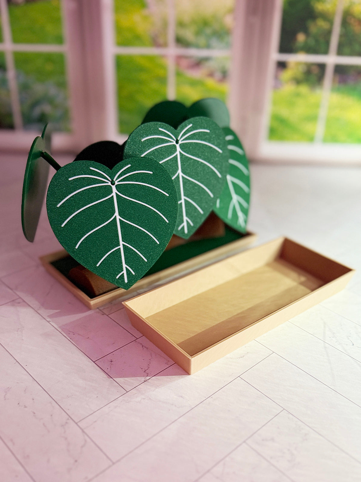 3D-printed Philodendron plowmanii coaster set with secret compartment displayed assembled as a decorative plant with detachable leaf coasters.