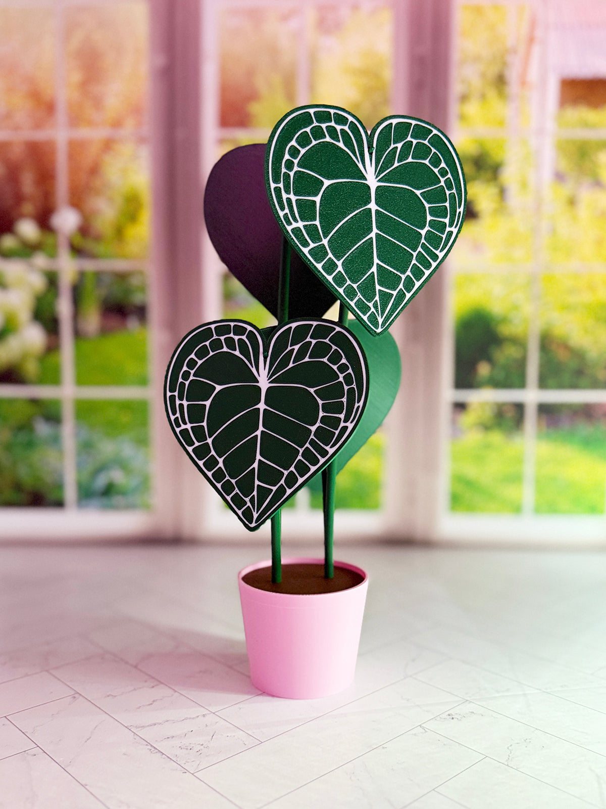 3D-printed Anthurium Clarinervium coaster set with hidden compartment displayed as a decorative plant with detachable heart-shaped leaf coasters.