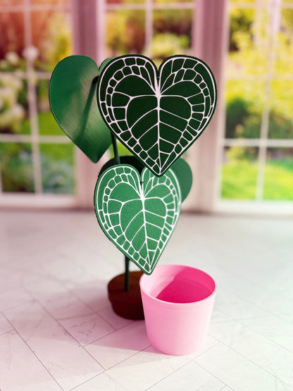 3D-printed Anthurium Clarinervium coaster set with hidden compartment displayed as a decorative plant with detachable heart-shaped leaf coasters.