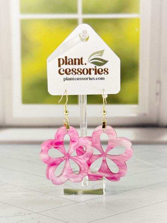 Handmade pink marble Hoya flower earrings with glitter, laser cut from acrylic and hanging on stainless steel hooks.