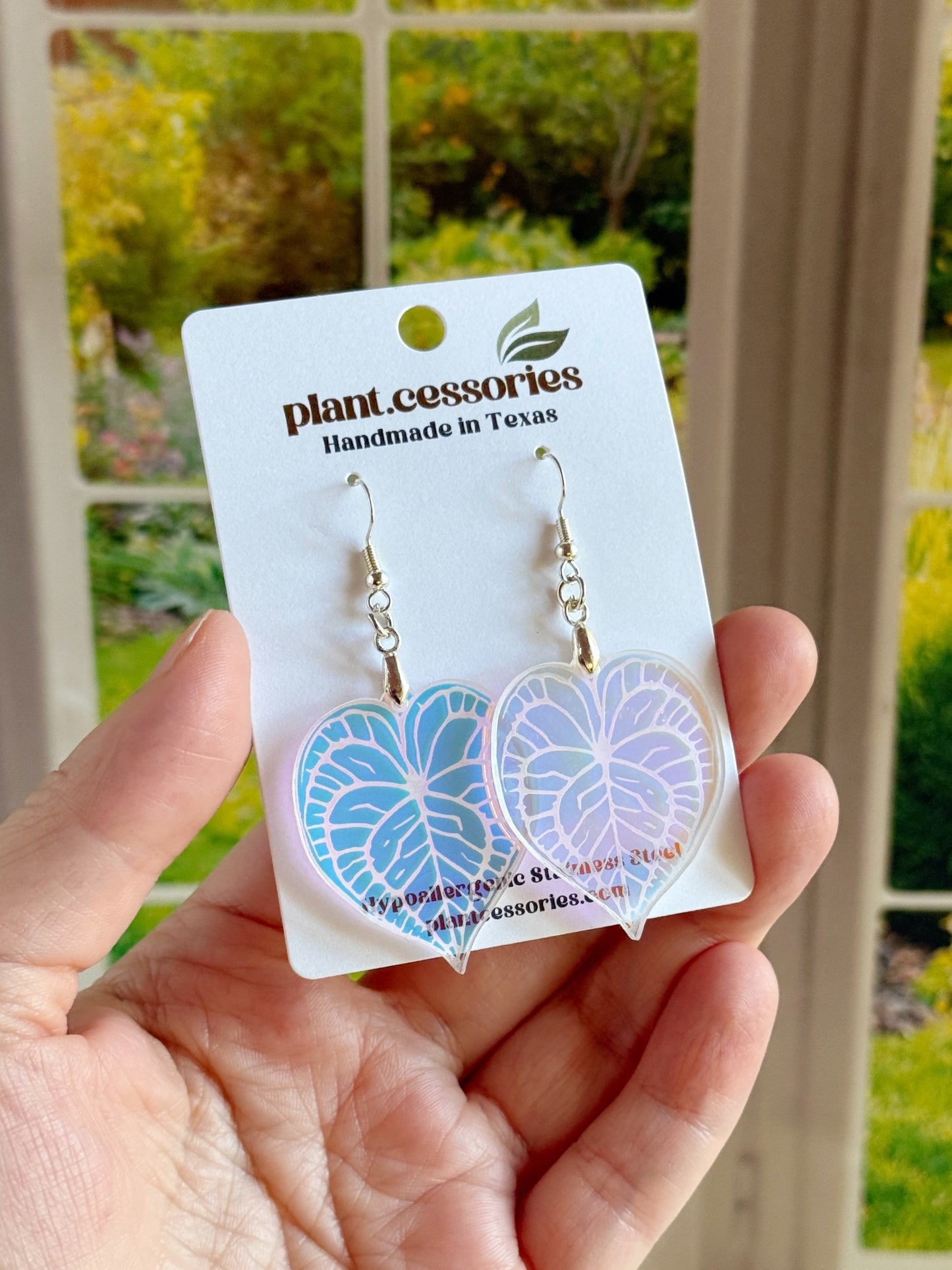 Hand-drawn and laser-cut Anthurium clarinervium leaf earrings with stainless steel hooks.