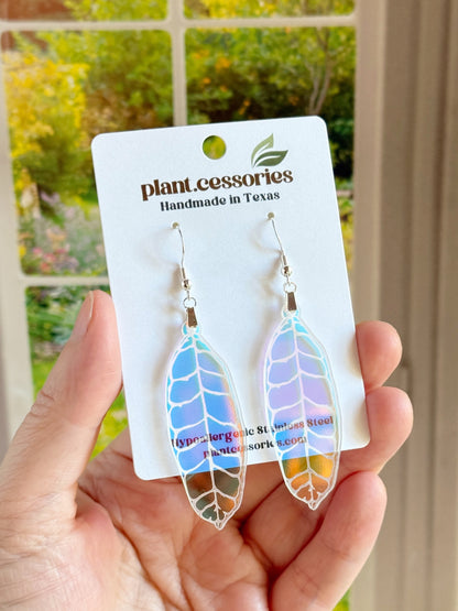 Hand-drawn and laser-cut iridescent Hoya callistophylla leaf earrings with stainless steel hooks.
