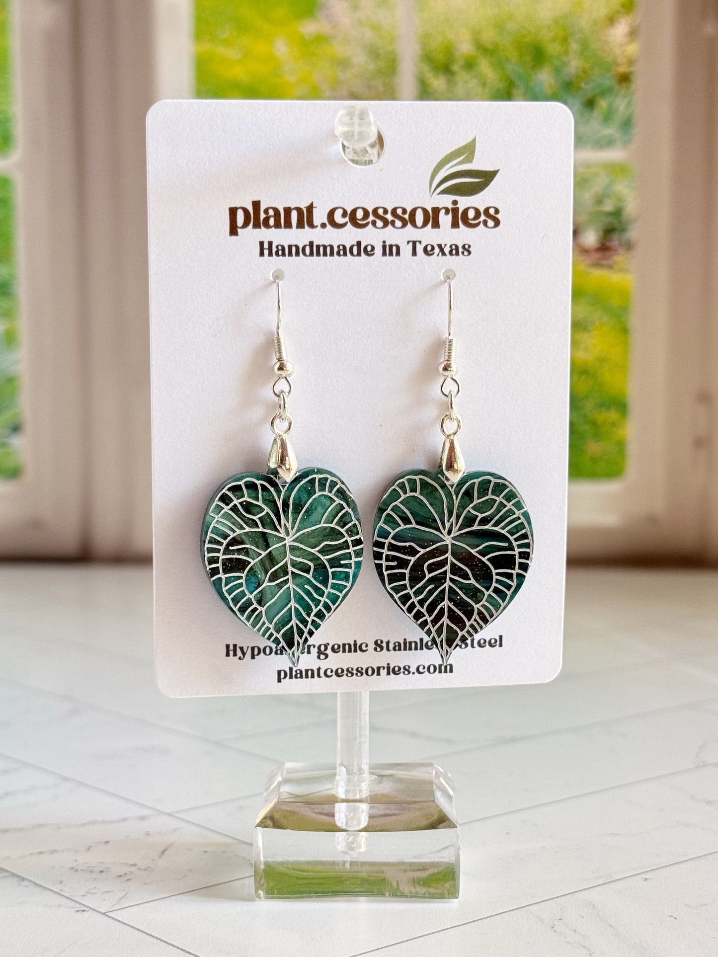 Galaxy green Anthurium clarinervium leaf earrings with hand-painted white vein details.