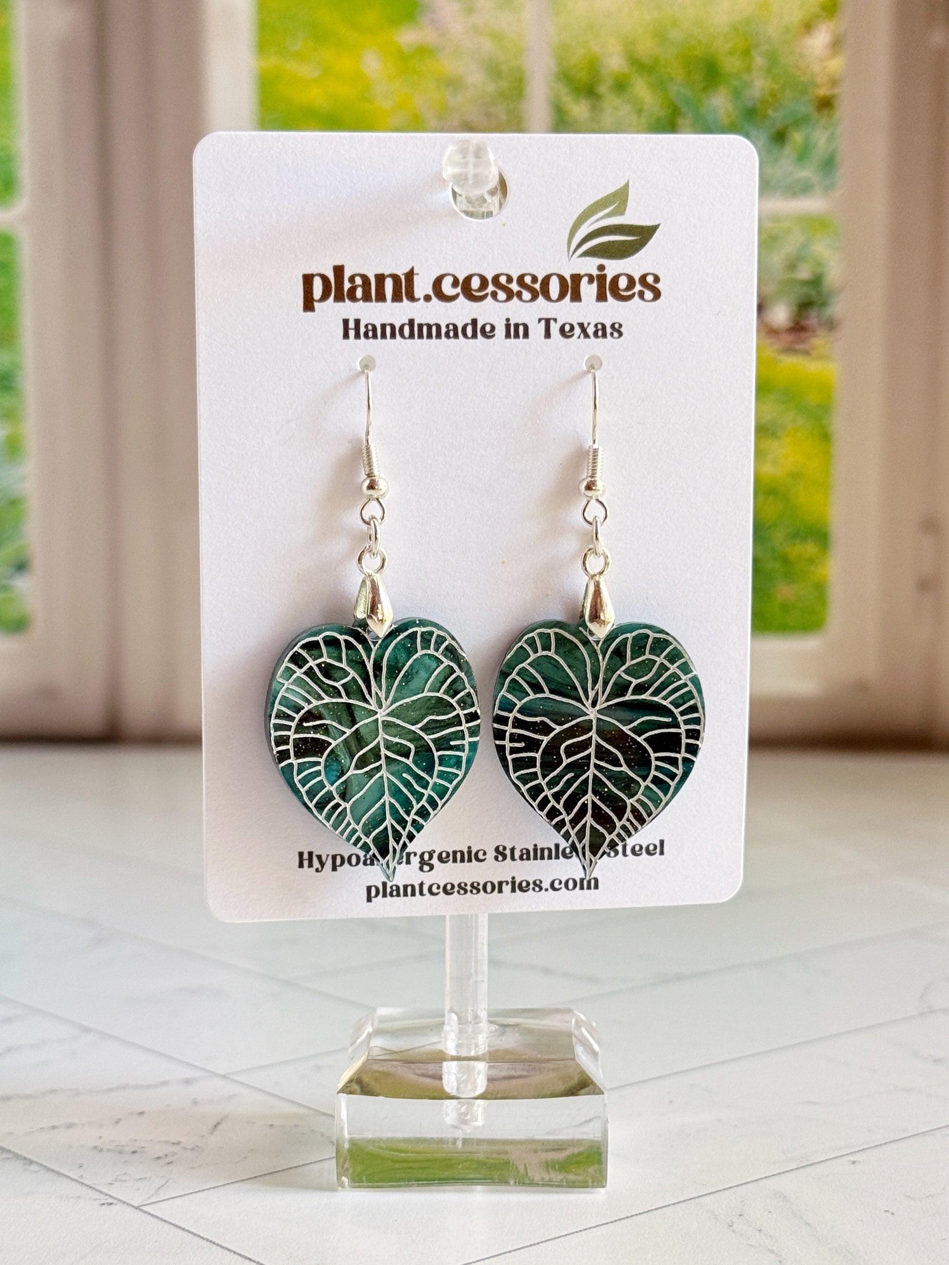 Galaxy green Anthurium clarinervium leaf earrings with hand-painted white vein details.