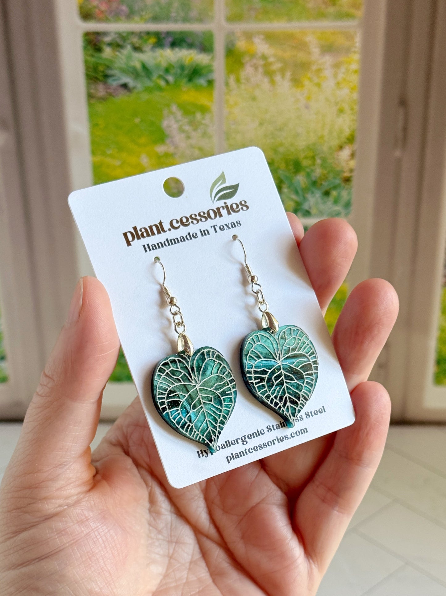 Galaxy green Anthurium clarinervium leaf earrings with hand-painted white vein details.