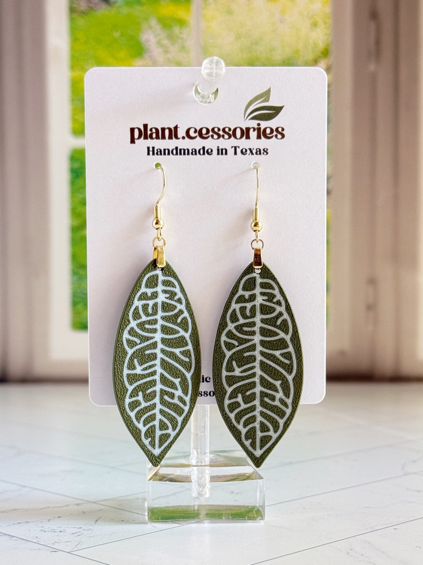 3D printed Hoya finlaysonii leaf earrings with white veining on green leaf design.