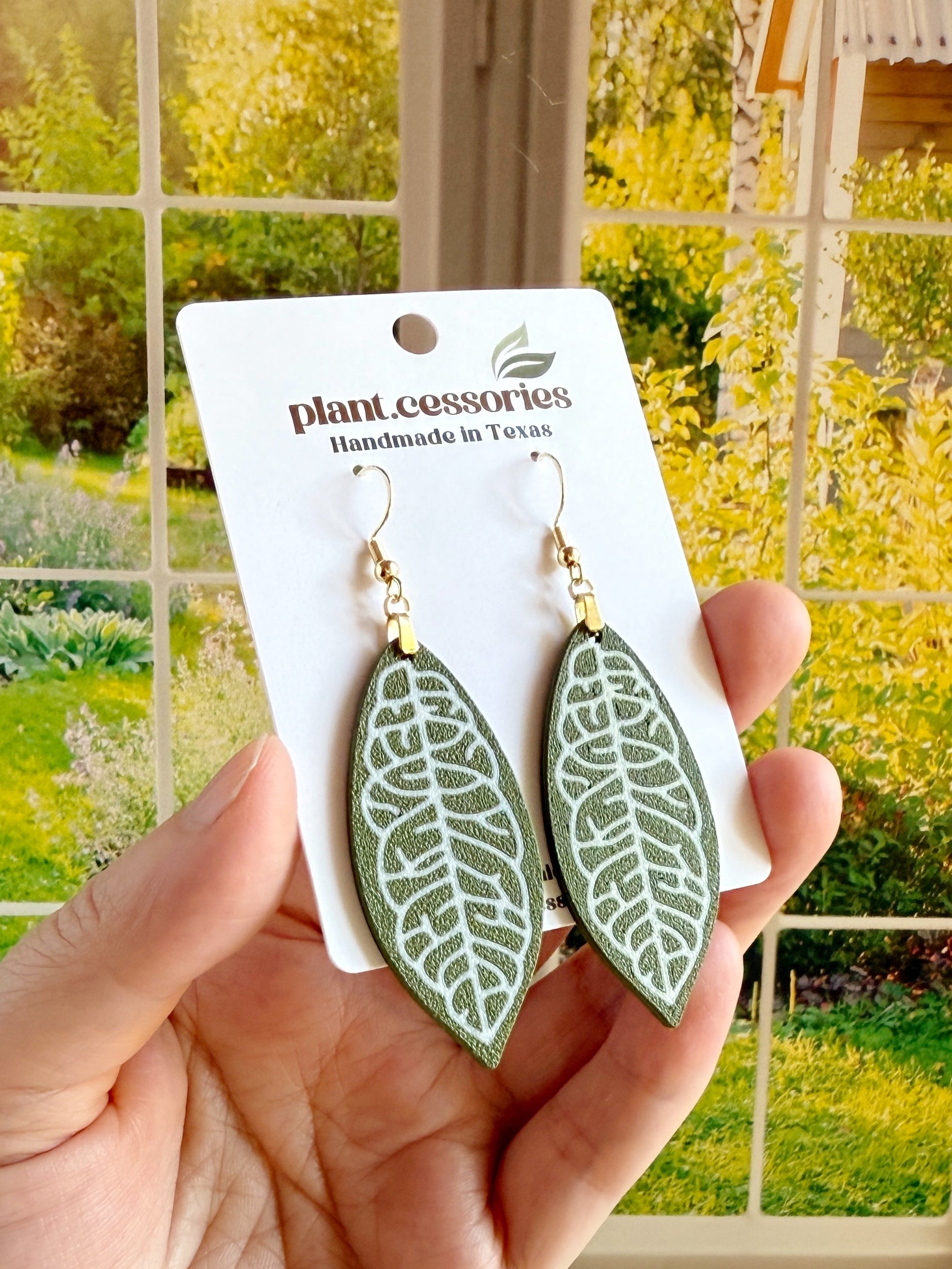 3D printed Hoya finlaysonii leaf earrings with white veining on green leaf design.