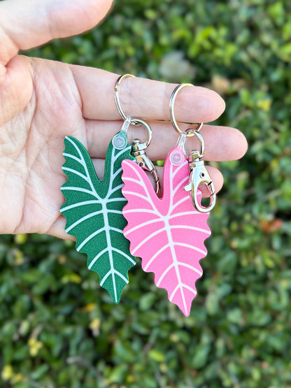 Green and pink Alocasia Amazonica leaf keychains and bag charms 3D printed from plant-based PLA.