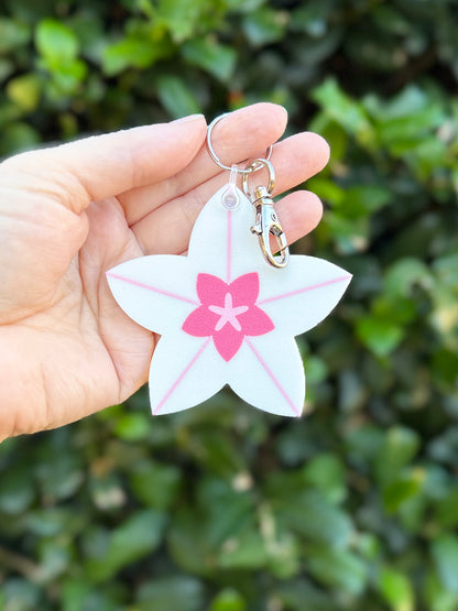 Hoya bloom keychain clipped to metal keyring and lobster clasp.