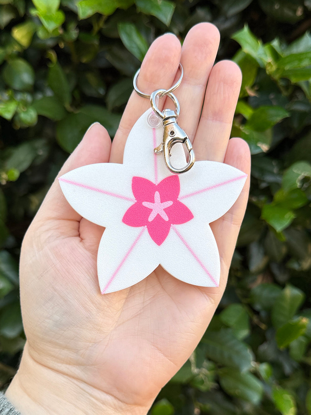 Hoya bloom keychain clipped to metal keyring and lobster clasp.
