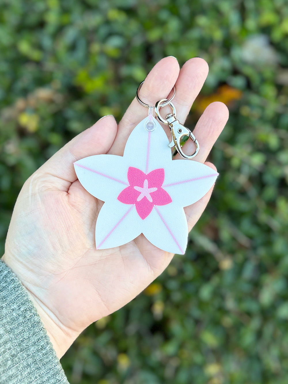 Hoya bloom keychain clipped to metal keyring and lobster clasp.