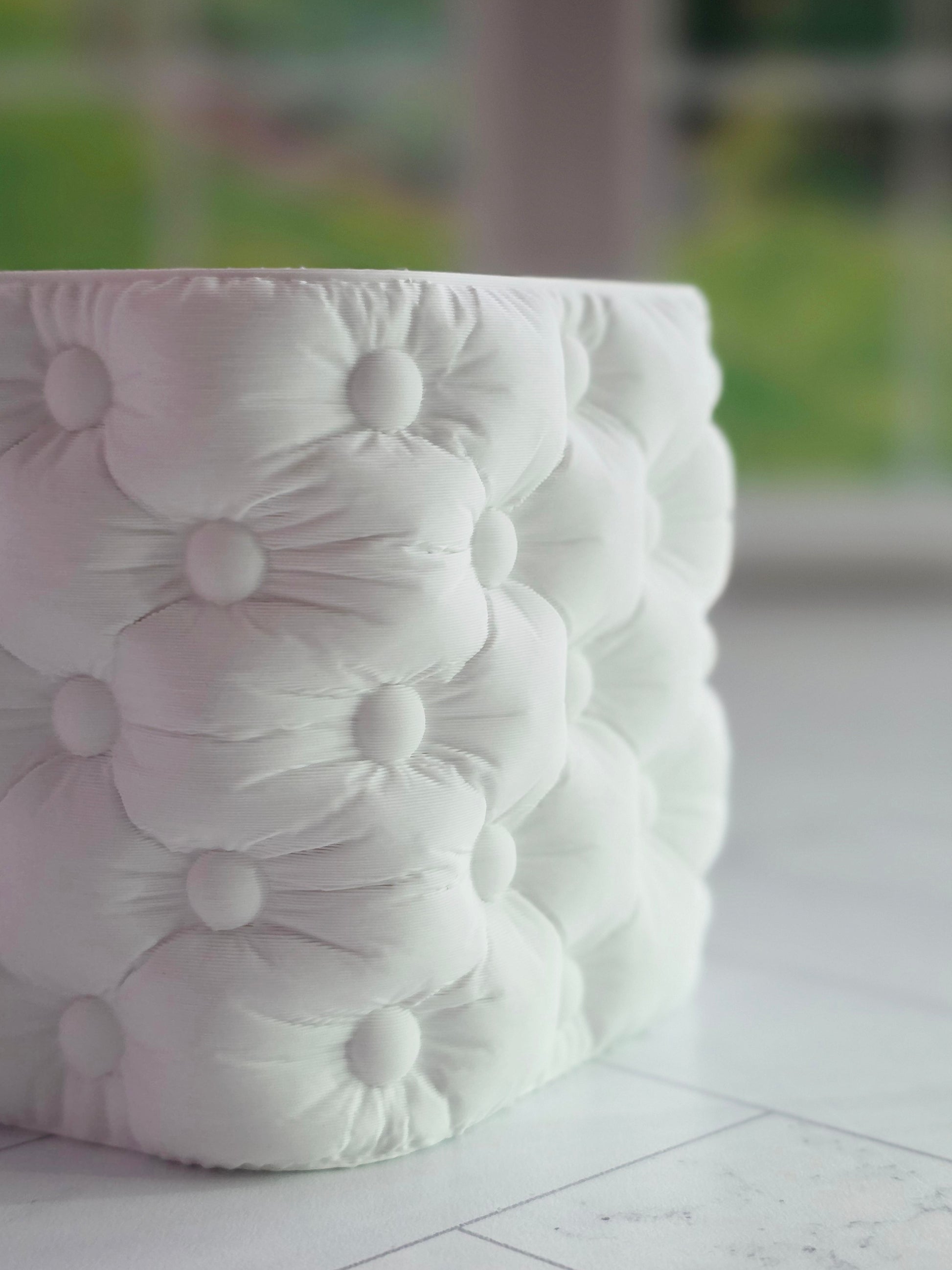 Tufted cube planter with a soft button-tufted texture and modern square shape, designed to fit a 2 inch square nursery pot