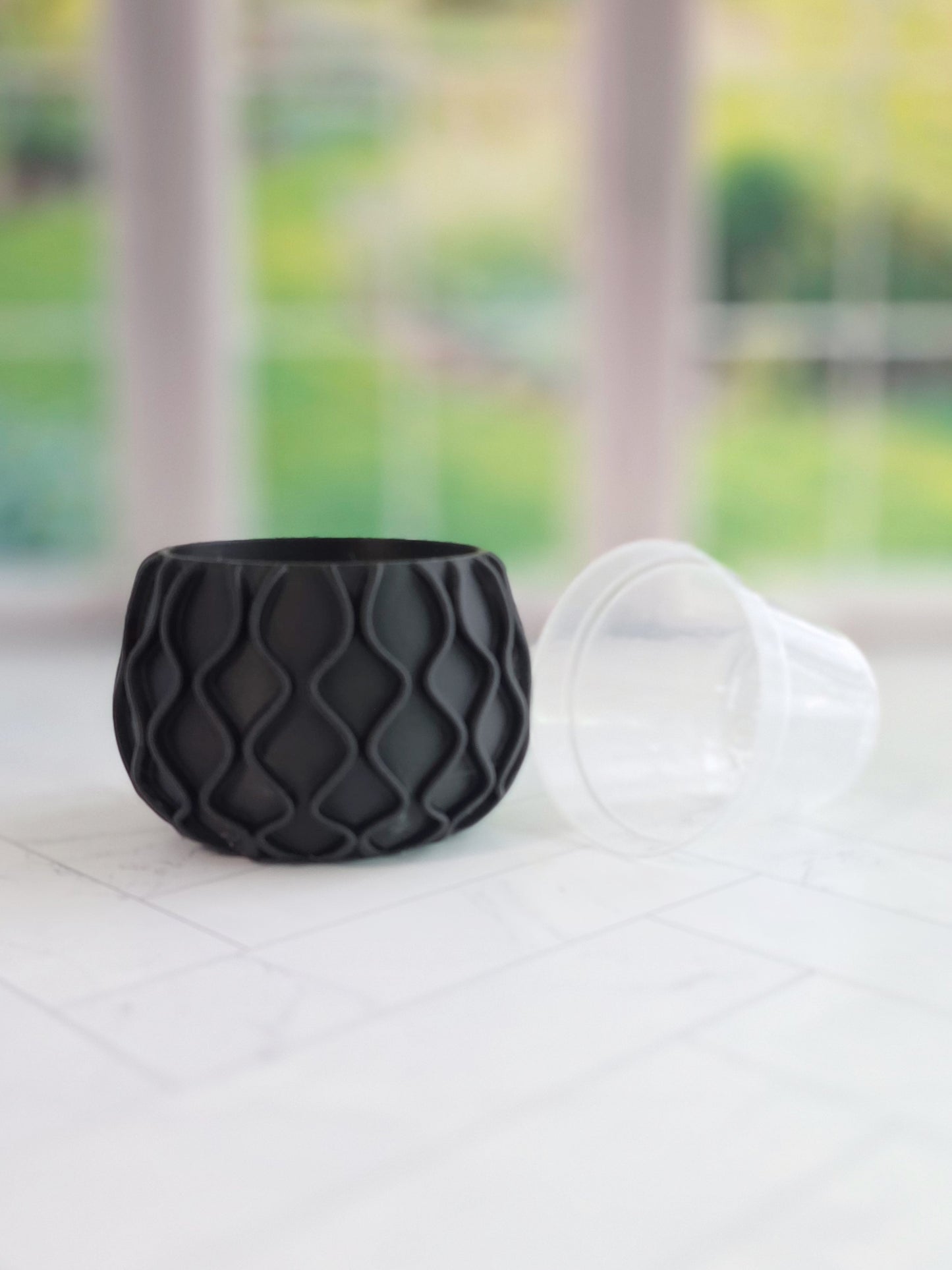 Mod wave planter with flowing textured ridges and a modern round shape, designed to fit a 2.5 inch round nursery pot