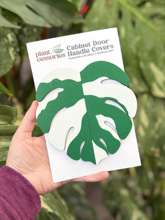 Slip-on Monstera Albo handle covers designed for IKEA greenhouse cabinet handles.
