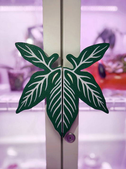 Syngonium leaf slip-on handle covers designed for IKEA greenhouse cabinet handles.