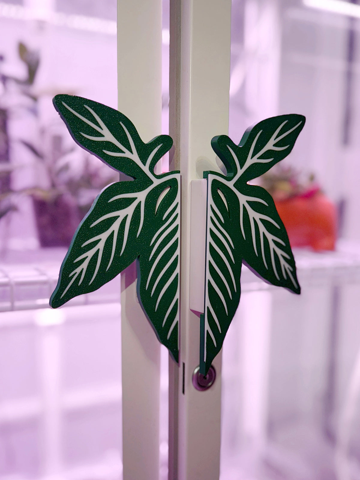 Syngonium leaf slip-on handle covers designed for IKEA greenhouse cabinet handles.