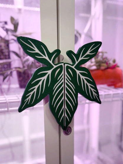 Syngonium leaf slip-on handle covers designed for IKEA greenhouse cabinet handles.