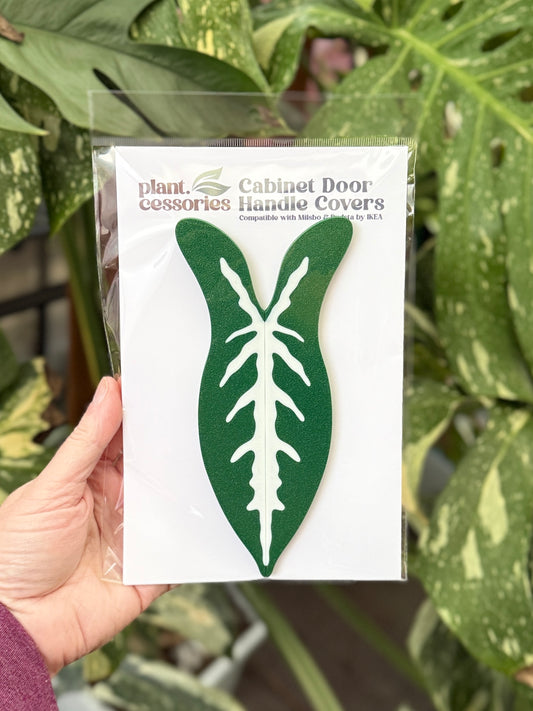 Slip-on Syngonium wendlandii handle covers designed for IKEA Milsbo and Rudsta greenhouse cabinet handles.
